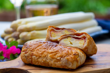 Pastry with bacon and white asparagus vegetables ready to eat served in spring garden