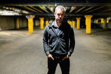 A portrait of a man inside basement at night