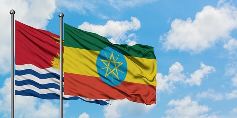 Kiribati and Ethiopia flag waving in the wind against white cloudy blue sky together. Diplomacy concept, international relations.