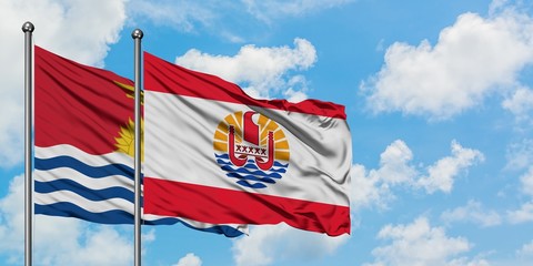Kiribati and French Polynesia flag waving in the wind against white cloudy blue sky together. Diplomacy concept, international relations.