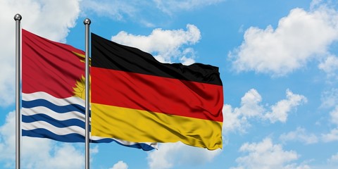 Kiribati and Germany flag waving in the wind against white cloudy blue sky together. Diplomacy concept, international relations.