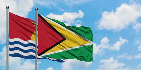 Kiribati and Guyana flag waving in the wind against white cloudy blue sky together. Diplomacy concept, international relations.