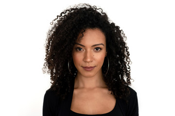 Isolated portrait of a latin woman with curly hair dressed in black