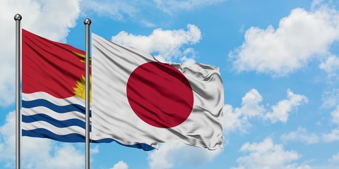 Kiribati and Japan flag waving in the wind against white cloudy blue sky together. Diplomacy concept, international relations.