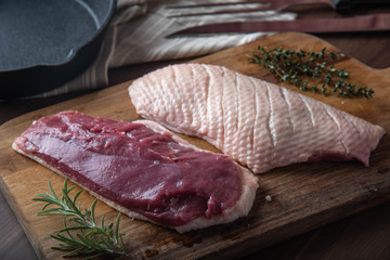 raw duck breast meat on cutting board
