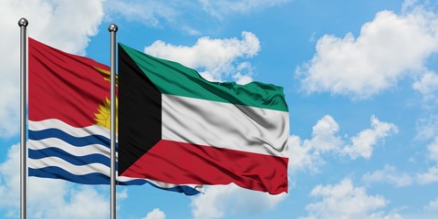 Kiribati and Kuwait flag waving in the wind against white cloudy blue sky together. Diplomacy concept, international relations.