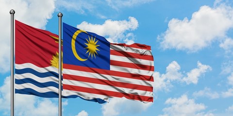 Kiribati and Malaysia flag waving in the wind against white cloudy blue sky together. Diplomacy concept, international relations.