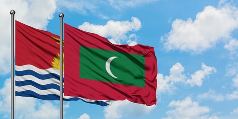 Kiribati and Maldives flag waving in the wind against white cloudy blue sky together. Diplomacy concept, international relations.