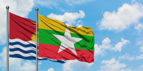 Kiribati and Myanmar flag waving in the wind against white cloudy blue sky together. Diplomacy concept, international relations.
