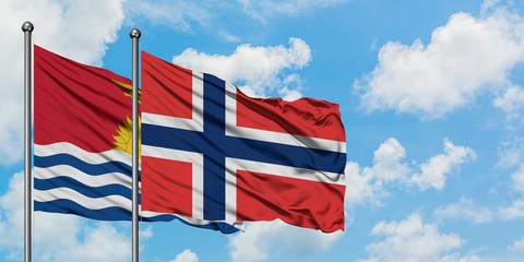 Kiribati and Norway flag waving in the wind against white cloudy blue sky together. Diplomacy concept, international relations.