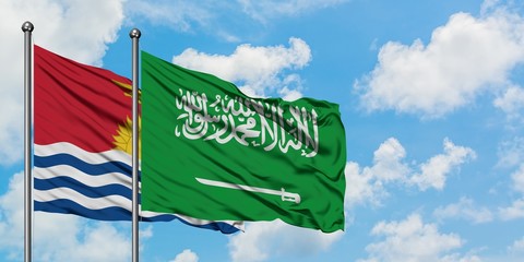 Kiribati and Saudi Arabia flag waving in the wind against white cloudy blue sky together. Diplomacy concept, international relations.