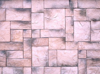 An interesting geometric pattern of ceramic tiles of different sizes. Colored stone background