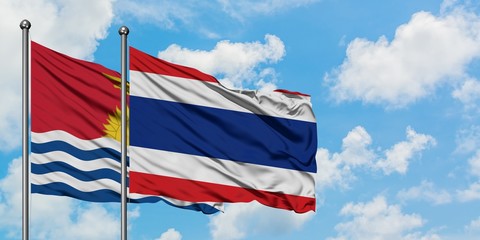 Kiribati and Thailand flag waving in the wind against white cloudy blue sky together. Diplomacy concept, international relations.
