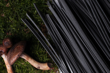 Italian spaghetti close-up shooting.Background texture.black spaghetti.