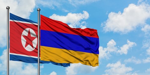 North Korea and Armenia flag waving in the wind against white cloudy blue sky together. Diplomacy concept, international relations.
