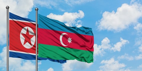 North Korea and Azerbaijan flag waving in the wind against white cloudy blue sky together. Diplomacy concept, international relations.
