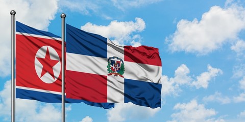 North Korea and Dominican Republic flag waving in the wind against white cloudy blue sky together. Diplomacy concept, international relations.