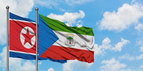 North Korea and Equatorial Guinea flag waving in the wind against white cloudy blue sky together. Diplomacy concept, international relations.