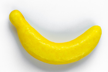 Big toy banana lies on a white background