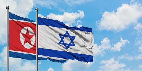 North Korea and Israel flag waving in the wind against white cloudy blue sky together. Diplomacy concept, international relations.