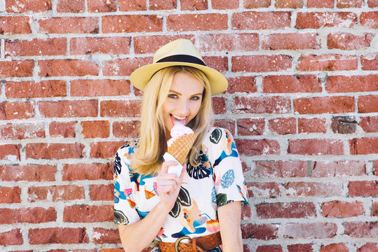 Woman flirts by licking ice cream while having fun