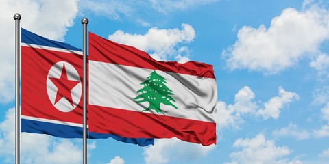 North Korea and Lebanon flag waving in the wind against white cloudy blue sky together. Diplomacy concept, international relations.