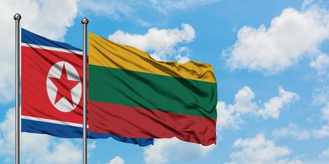 North Korea and Lithuania flag waving in the wind against white cloudy blue sky together. Diplomacy concept, international relations.