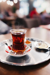 Holding a traditional Turkish Tea Glass