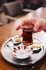 Holding a traditional Turkish Tea Glass