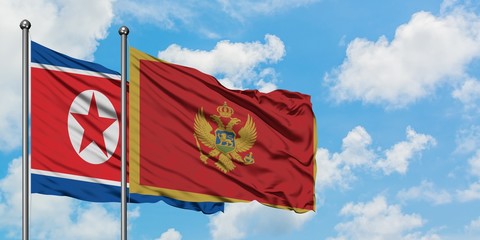 North Korea and Montenegro flag waving in the wind against white cloudy blue sky together. Diplomacy concept, international relations.