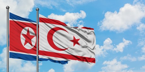 North Korea and Northern Cyprus flag waving in the wind against white cloudy blue sky together. Diplomacy concept, international relations.