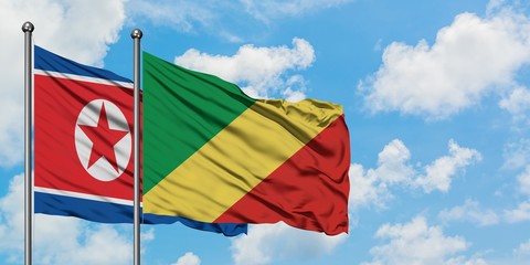 North Korea and Republic Of The Congo flag waving in the wind against white cloudy blue sky together. Diplomacy concept, international relations.