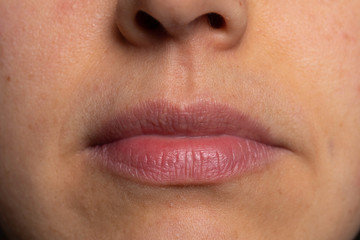 Woman mouth with closed lips close up view