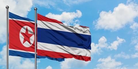 North Korea and Thailand flag waving in the wind against white cloudy blue sky together. Diplomacy concept, international relations.