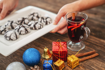 Perparing traditional cookies and gluhwein or mulled wine for new year celebration