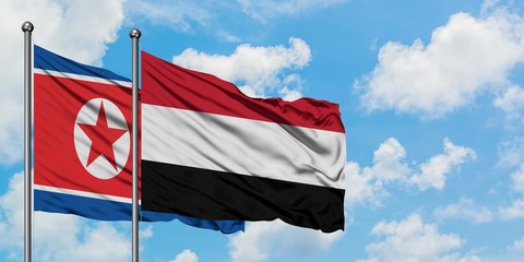 North Korea and Yemen flag waving in the wind against white cloudy blue sky together. Diplomacy concept, international relations.