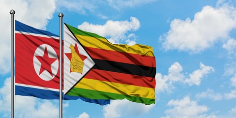 North Korea and Zimbabwe flag waving in the wind against white cloudy blue sky together. Diplomacy concept, international relations.