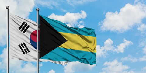 South Korea and Bahamas flag waving in the wind against white cloudy blue sky together. Diplomacy concept, international relations.