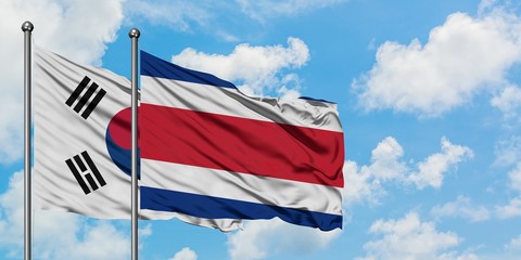 South Korea and Costa Rica flag waving in the wind against white cloudy blue sky together. Diplomacy concept, international relations.