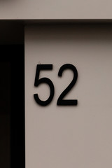 black number 52 on white wall