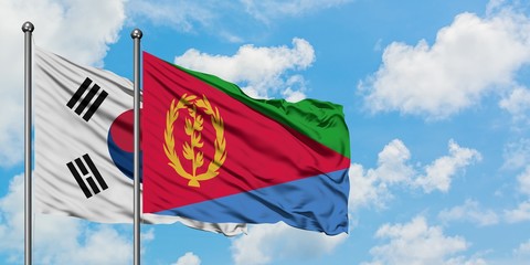 South Korea and Eritrea flag waving in the wind against white cloudy blue sky together. Diplomacy concept, international relations.
