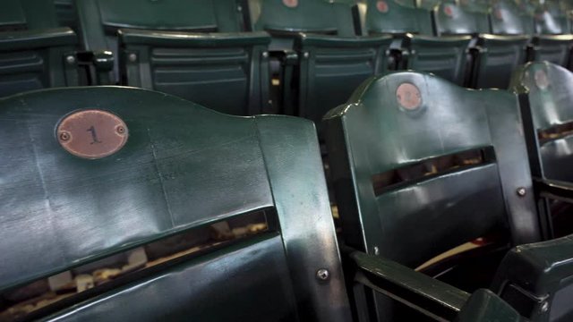 Numbers one and two Indoor Hockey Seating with Empty Green fold up seats.
