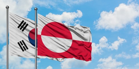South Korea and Greenland flag waving in the wind against white cloudy blue sky together. Diplomacy concept, international relations.