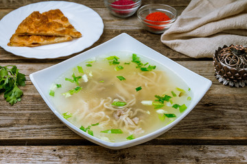 lamb noodle soup on wooden table