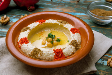 Traditional homemade hummus on wooden table