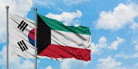 South Korea and Kuwait flag waving in the wind against white cloudy blue sky together. Diplomacy concept, international relations.