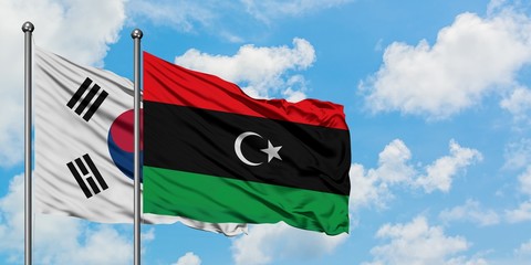 South Korea and Libya flag waving in the wind against white cloudy blue sky together. Diplomacy concept, international relations.