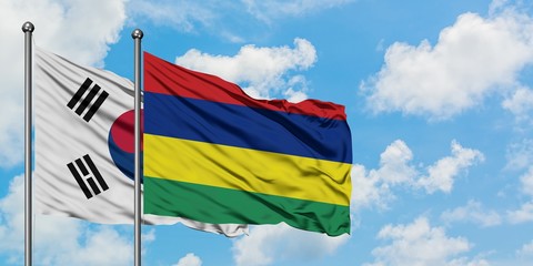 South Korea and Mauritius flag waving in the wind against white cloudy blue sky together. Diplomacy concept, international relations.