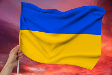 photo of the beautiful colored national flag of the modern state of Ukraine on textured fabric, concept of tourism, emigration, economics and politics, closeup