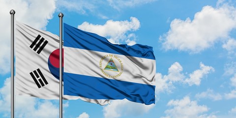 South Korea and Nicaragua flag waving in the wind against white cloudy blue sky together. Diplomacy concept, international relations.